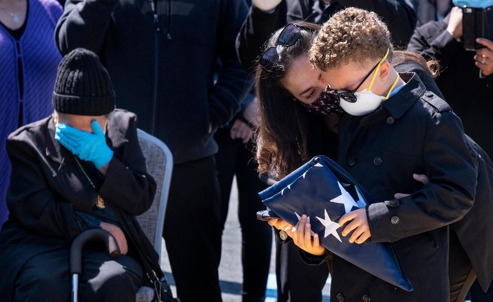 Robert Cardona Jr., 9, holds the flag that
