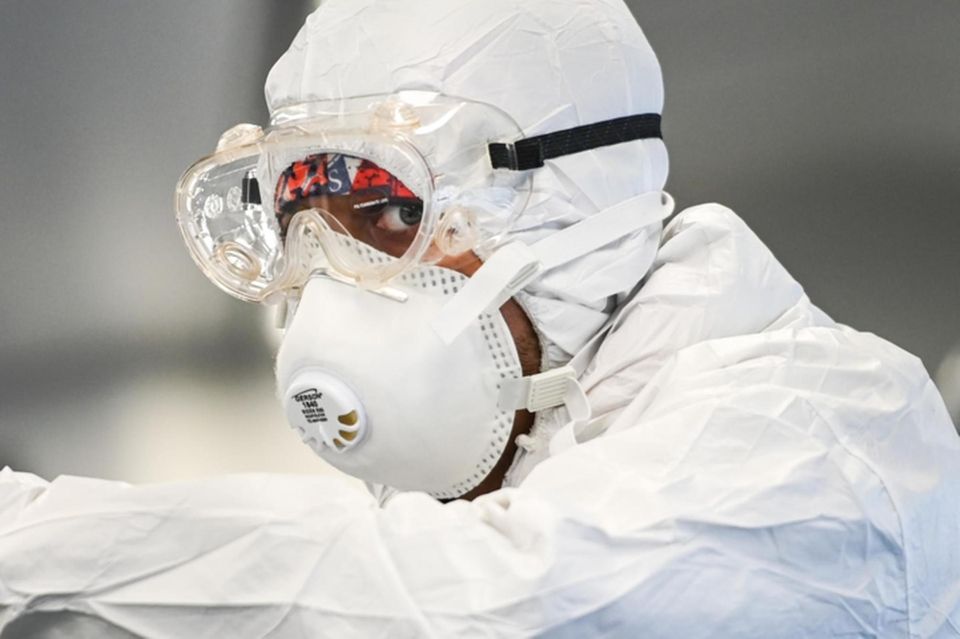 A Long Island Rail Road employee disinfects a