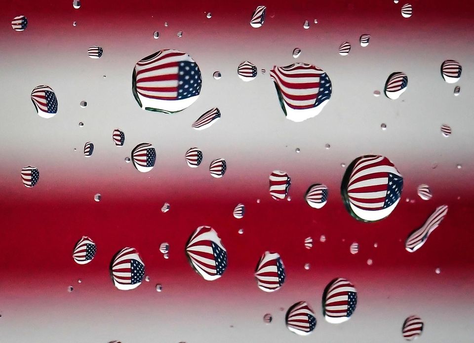 An American flag wall mural is refracted through