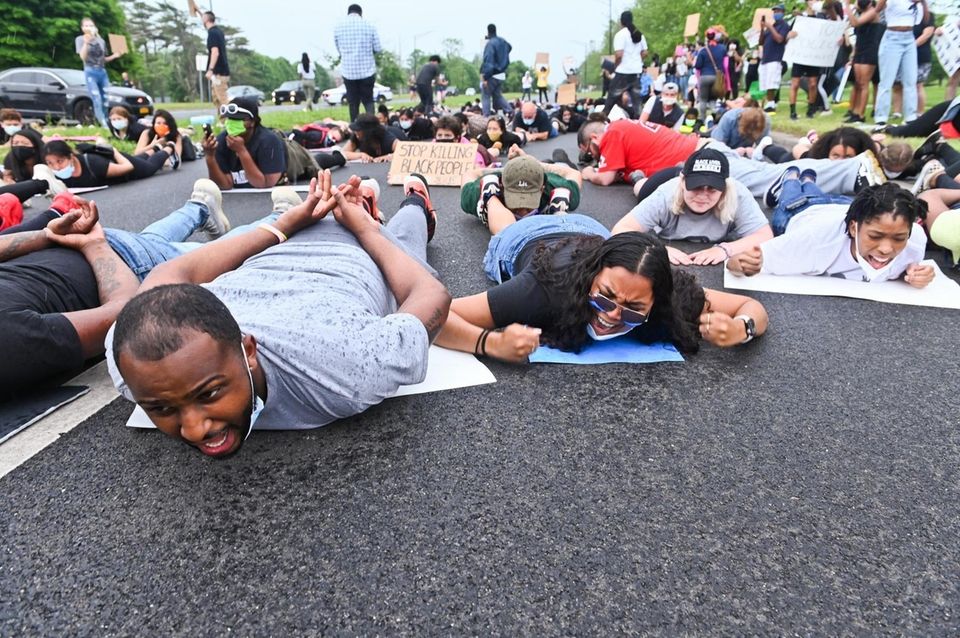Protestors chant on the ground while walking down