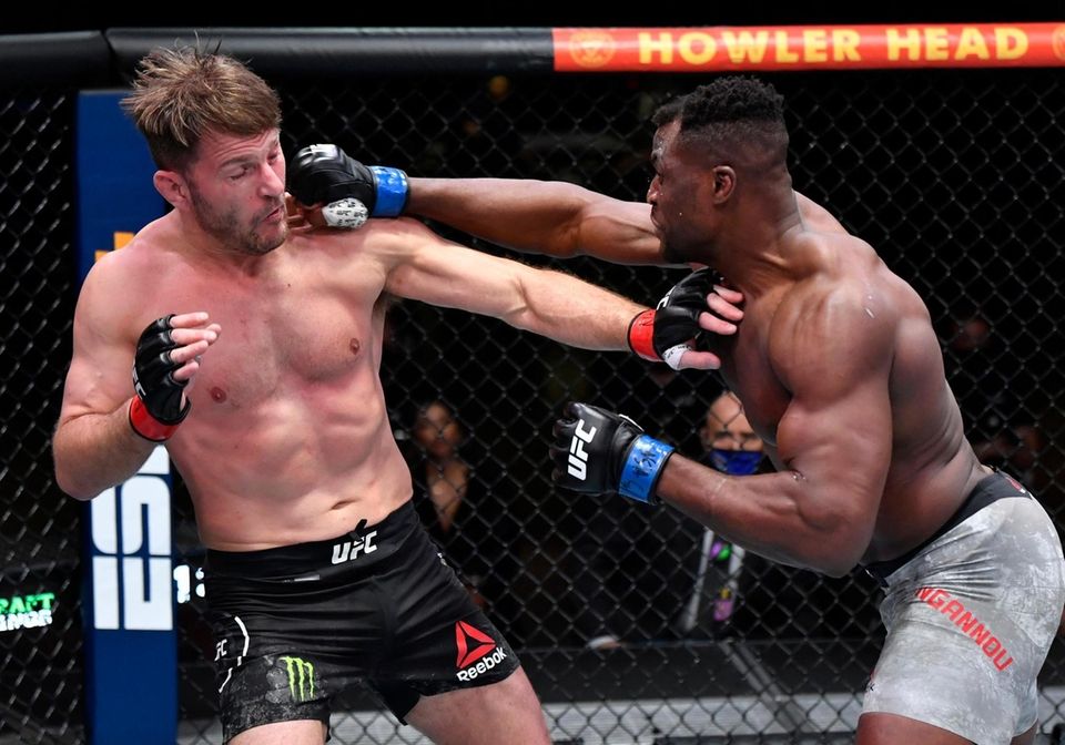 Francis Ngannou punches Stipe Miocic in their UFC
