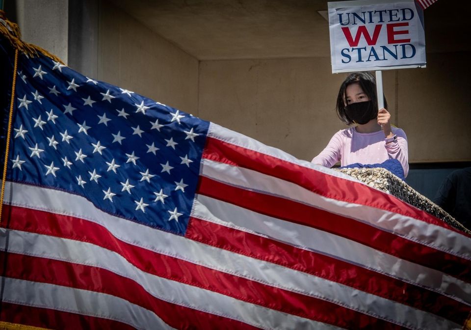 A young girl holding a sign at the