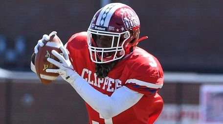 Bellport's Ka'Shaun Parrish completes a pass from quarterback