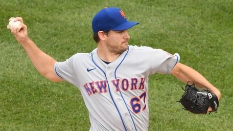 Seth Lugo of the Mets pitches in the