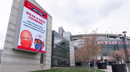 An electronic sign encouraging mask-wearing is seen at