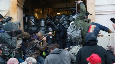 Supporters of President Donald Trump fight police at