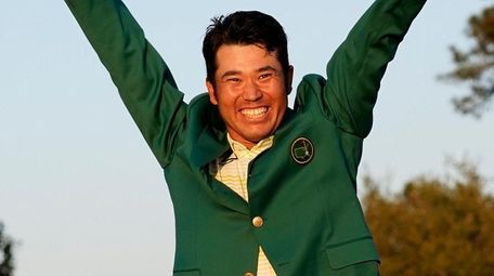 Hideki Matsuyama celebrates after putting on the champion's