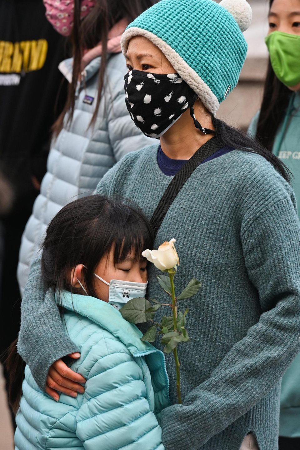 Yan Cao, of Garden City, alongside her daughter