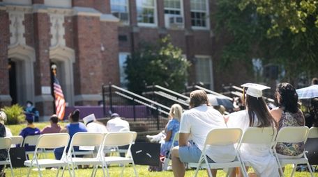 Students and parents maintain social distance as they