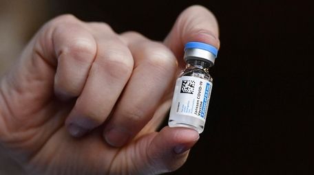 The Johnson & Johnson COVID-19 vaccine is held