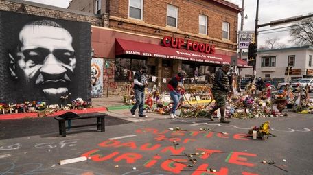 Visitors browse a memorial to George Floyd as