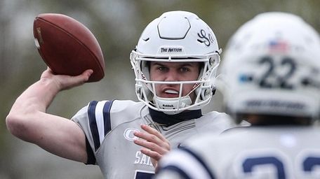 Oceanside quarterback Charlie McKee passes to Ronnie Kraemer