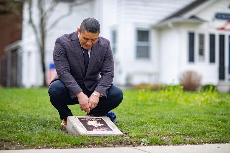 Joselo Lucero gazes at a plaque dedicated to