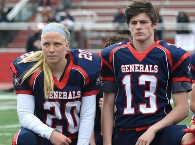 Alyssa Accordino #20, MacArthur kicker, kneels alongside Sean