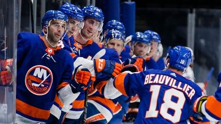 Islanders' Anthony Beauvillier (18) celebrates with teammates after