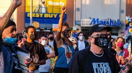 Demonstrators gather at the Barclays Center and react