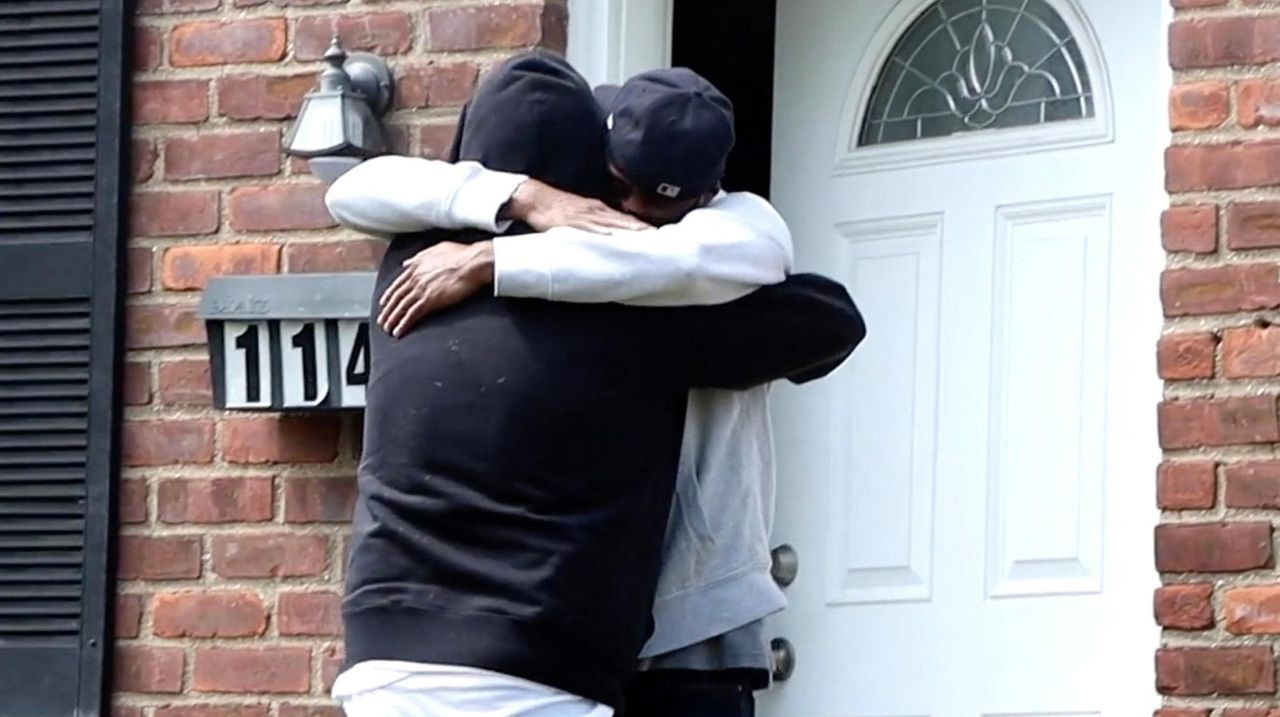 Joe Aggerup and Manny Baksh embrace as they