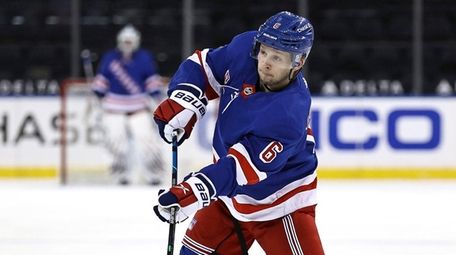 Rangers' Zac Jones passes the puck during a