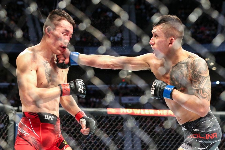 Aoriqileng, left, takes a punch from Jeffrey Molina