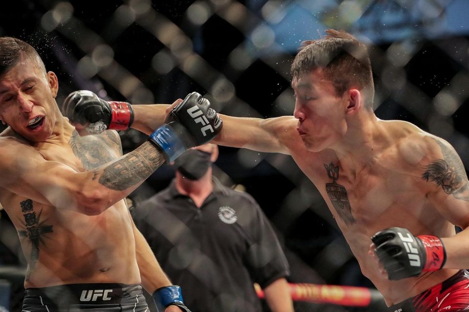 Aoriqileng of China punches Jeffrey Molina of the