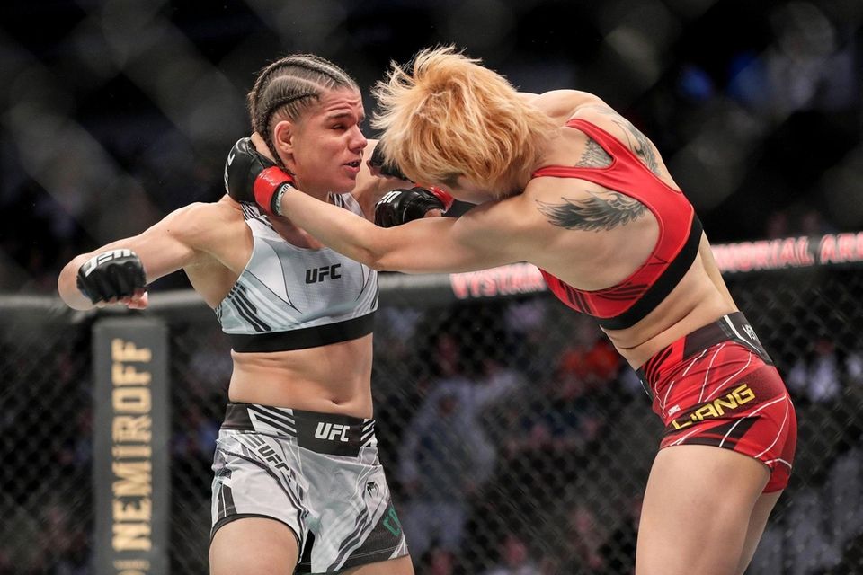 Ariane Carnelossi of Brazil (L) punches Liang Na