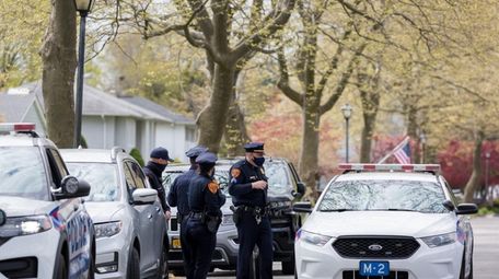 Suffolk County Police Department officers keep watch outside