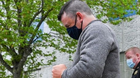 Matthew Gallagher, 37, of Rocky Point, is led