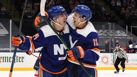 Islanders center Mathew Barzal, right, congratulates center Jean-Gabriel