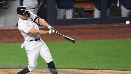 Yankees designated hitter Giancarlo Stanton doubles against the