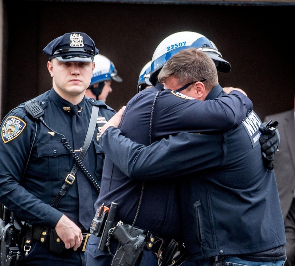 NYPD Highway Patrol Officers hugging Anastasios Tsakos' partner