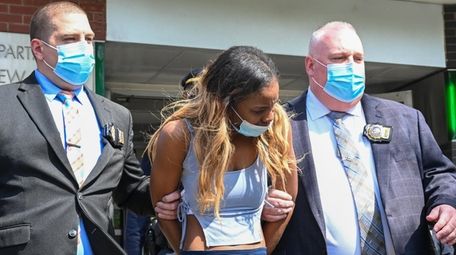 Jessica Beauvais, of Hempstead, is led out of