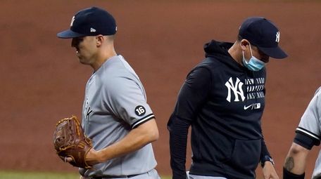 Yankees starting pitcher Jameson Taillon, left, is taken