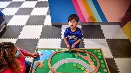 Logan Chavarria, 3, plays at the Kiddie Clubhouse