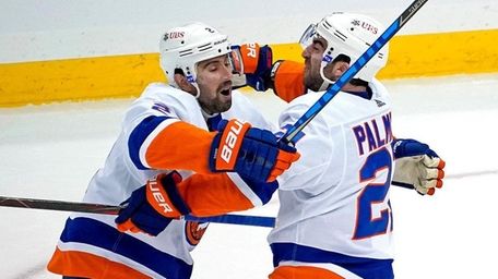 The Islanders' Kyle Palmieri, center, celebrates with Nick