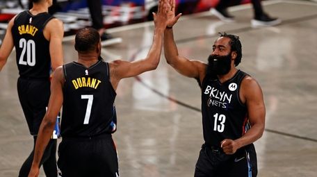 Nets guard James Harden (13) high-fives forward Kevin