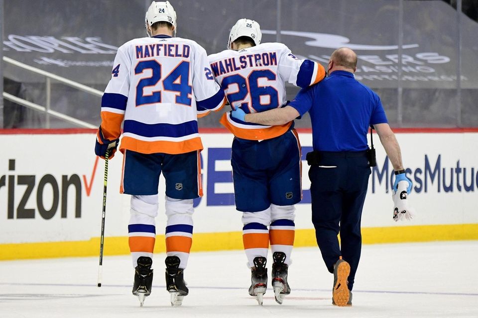 Oliver Wahlstrom of the Islanders is led off