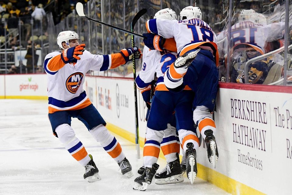 The New York Islanders celebrate the game winning