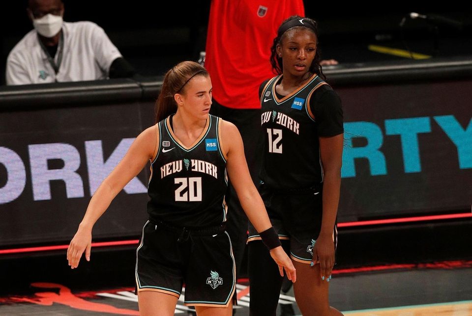 Sabrina Ionescu #20 and Michaela Onyenwere #12 of