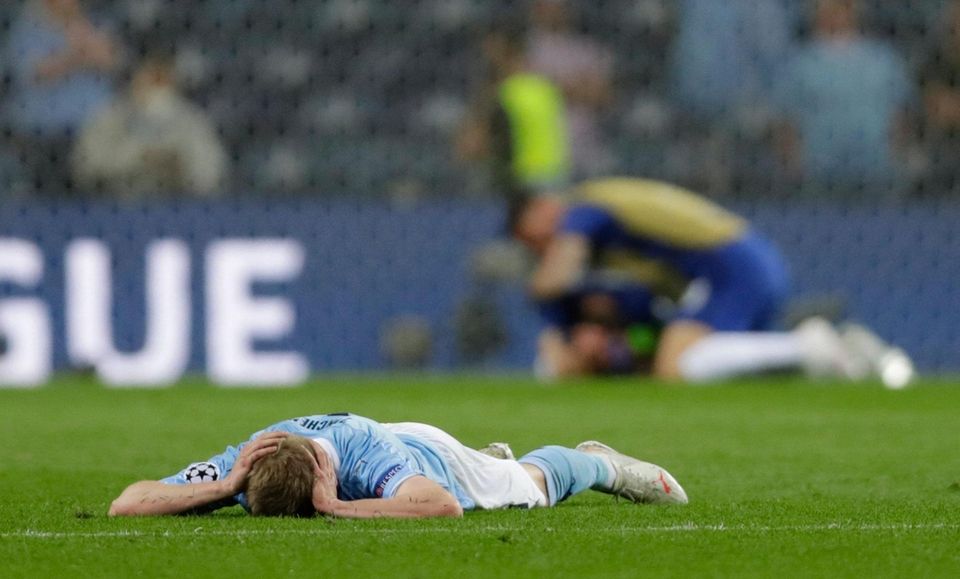 Manchester City's Ukrainian midfielder Oleksandr Zinchenko (L) reacts