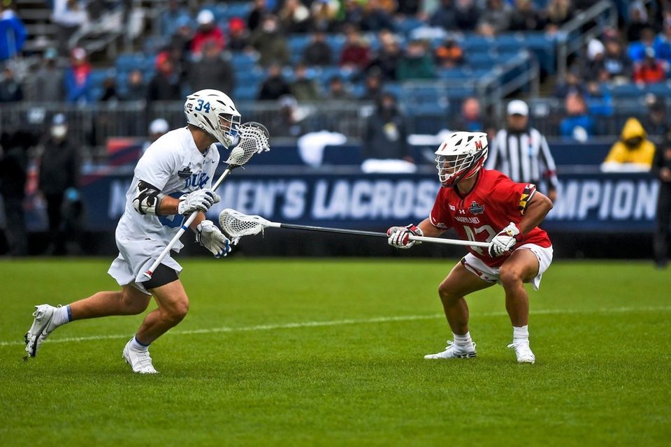 Duke's Brennan O'Neill (34) is guarded by Maryland's
