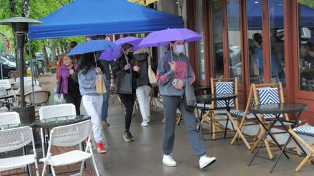 People walked under umbrellas Sunday in Southampton, some