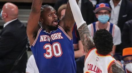 Knicks forward Julius Randle takes a three-point shot