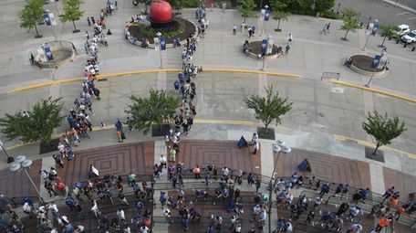 Fans wait to enter Citi Field before an