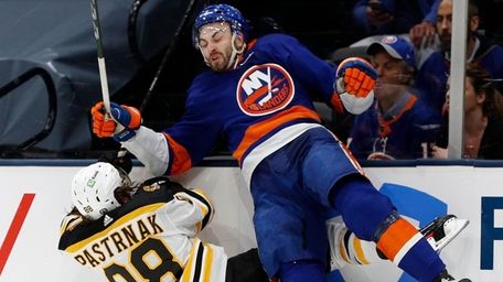 Adam Pelech of the New York Islanders checks