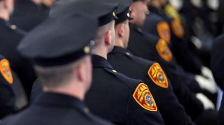 Police recruits take part in the commencement ceremony