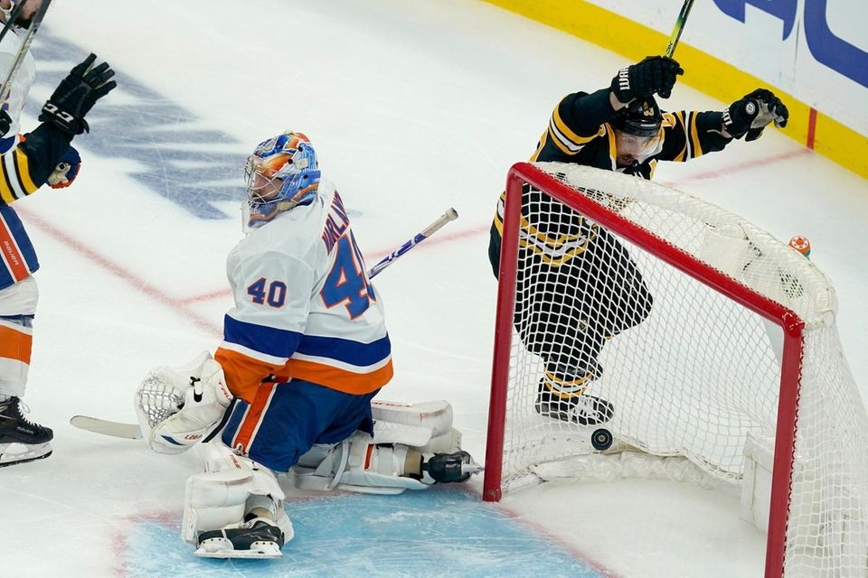 Boston Bruins center Brad Marchand, right, celebrates a