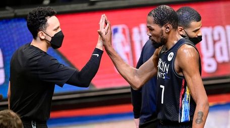 Kevin Durant of the Nets congratulated by Landry