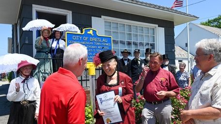 Museum director Marianne Guglieri accepts a proclamation from