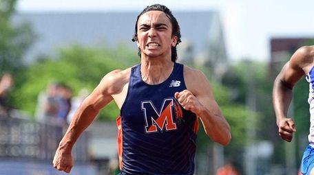 Marco Motroni of Manhasett wins the boys 100