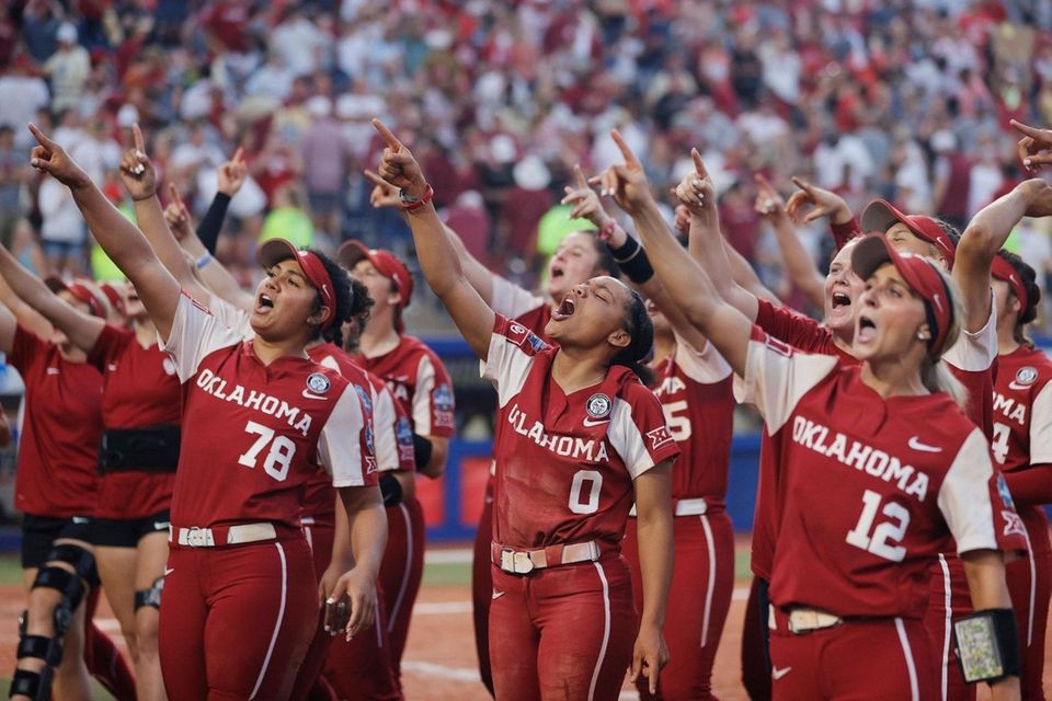 The Oklahoma Sooners celebrate with fans during the
